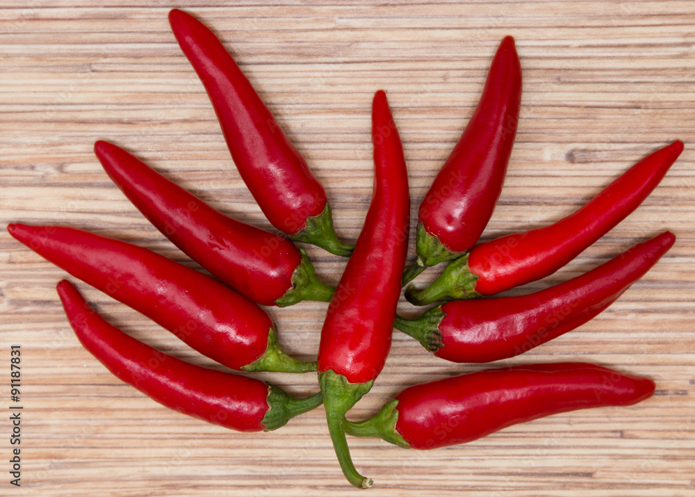 red hot peppers on wooden background