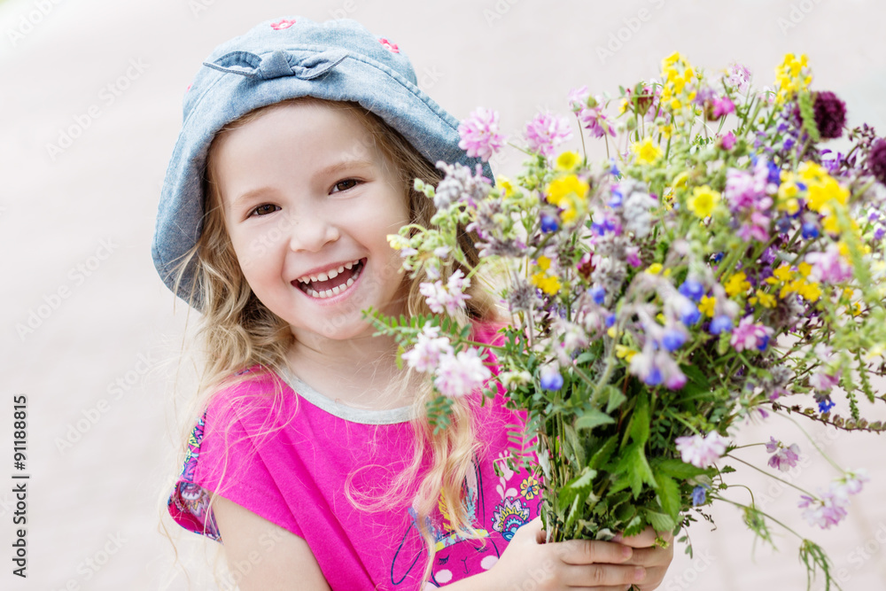 Happy toddler girl holding a bouquet Happy toddler girl holding a bouquet