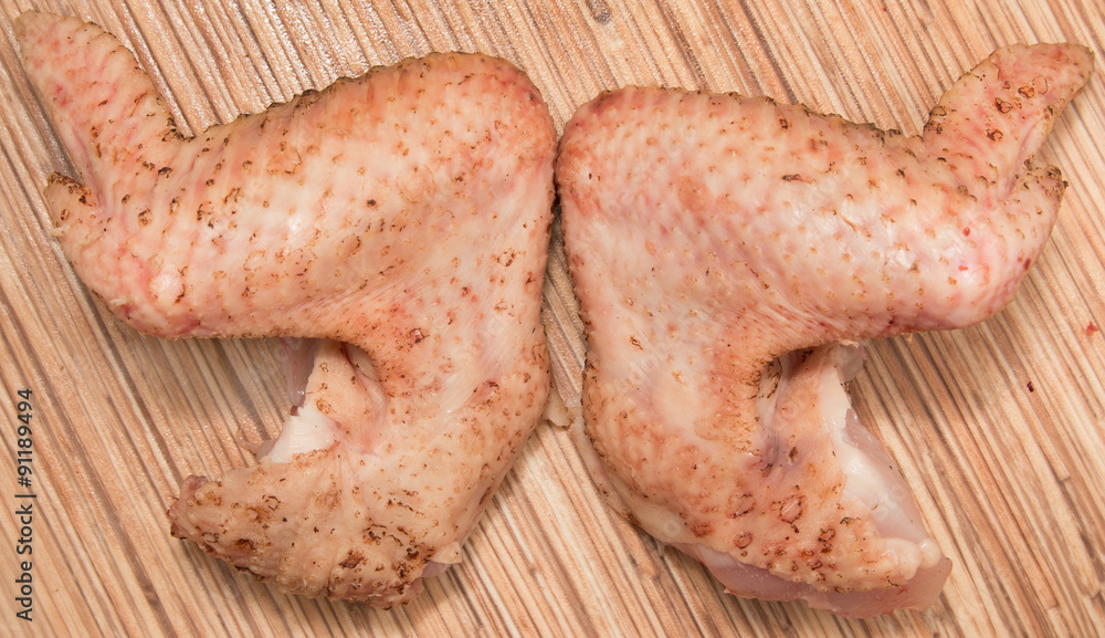 Fresh chicken wings on wooden background Fresh chicken wings on wooden background