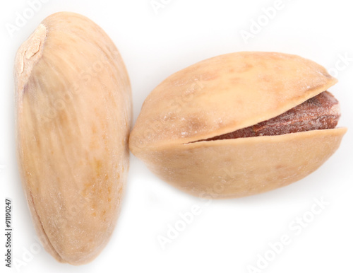 Salted pistachios on white background