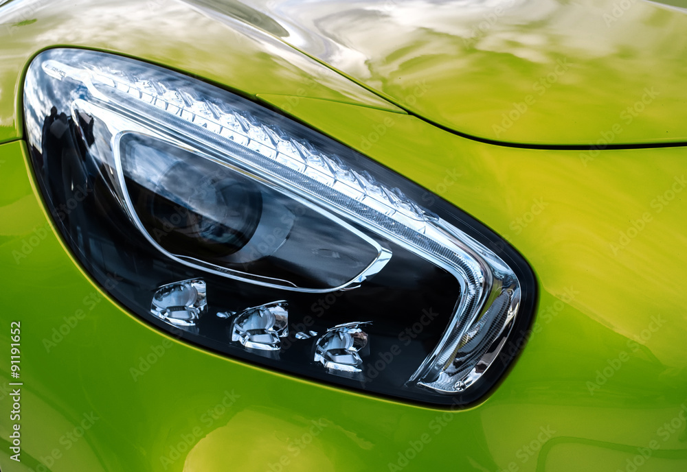 Closeup headlights of modern sport yellow car. Car exterior deta - obrazy, fototapety, plakaty 