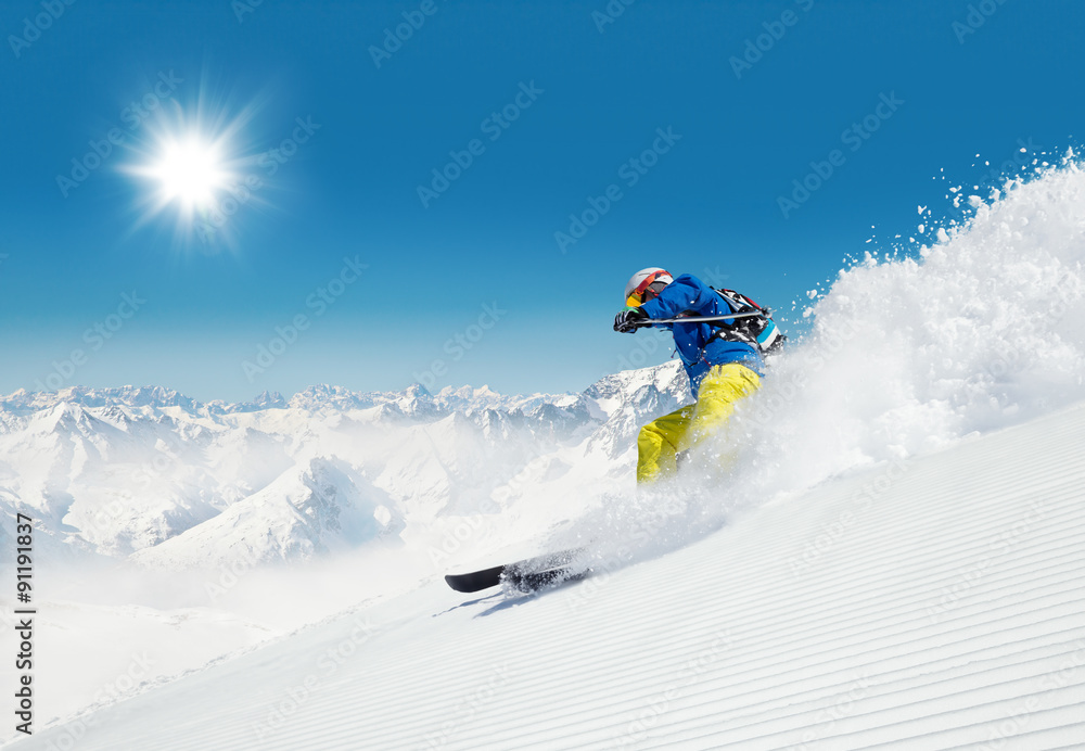 Man skier running downhill