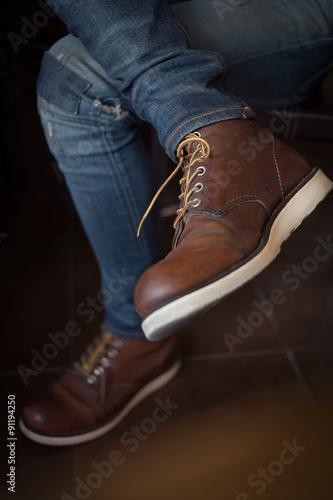 brown boot leather shoes and jean pants clothing