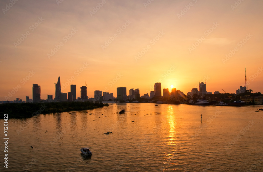 Ho Chi Minh's Panorama view over the Saigon River. Dramatic lighting spectacular sunset is highlighted by a canoe surfing on the water at a faster rate