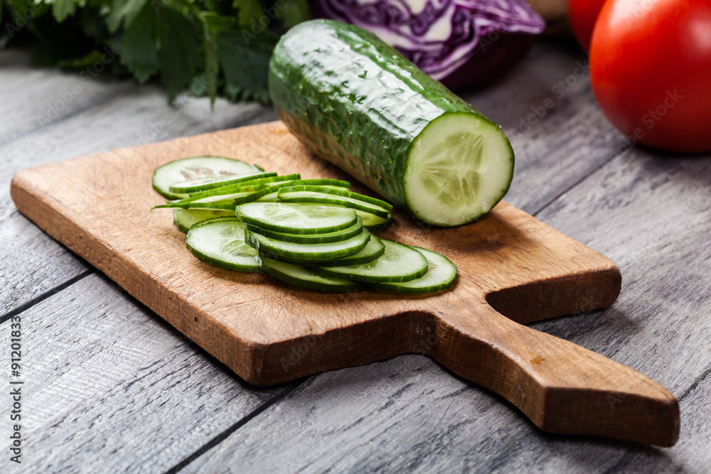 Chopped vegetables: cucumber on cutting board Chopped vegetables: cucumber on cutting board