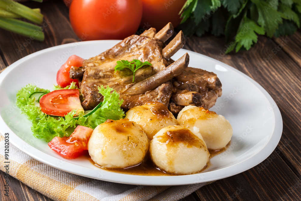 Pork spareribs served with silesian noodles and sauce Pork spareribs served with silesian noodles and sauce
