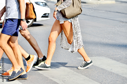 Young adults crossing street