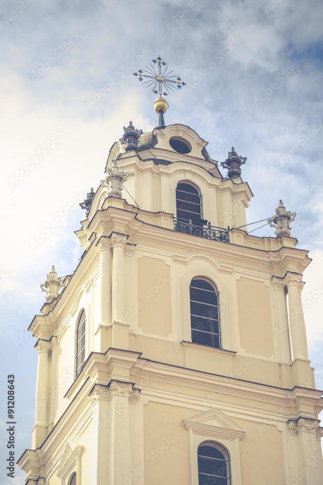 bell tower in the morning light in Vilnius on background blue sk