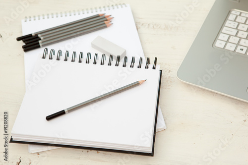 Wallpaper Mural Two sketchpads, pencils and eraser on the white wooden table Torontodigital.ca