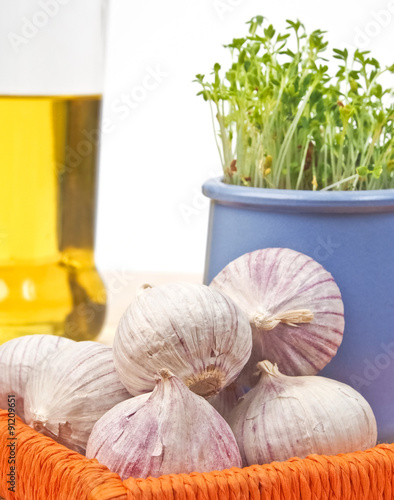 Garlic and cress with olive oil in background
