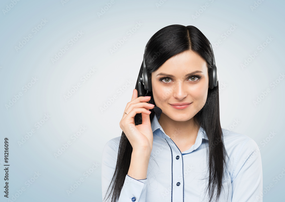 Front view of the smiling brunette support phone operator with headset. Isolated on white background. Front view of the smiling brunette support phone operator with headset. Isolated on white background.