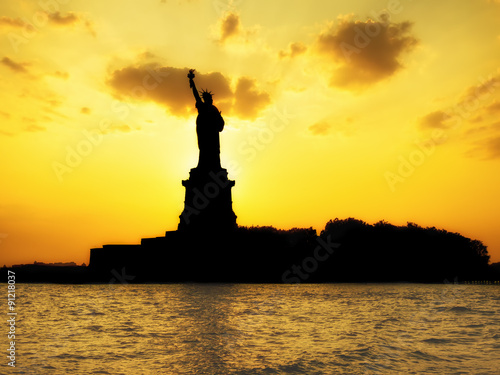 Silhouette of the Statue of Liberty at sunset