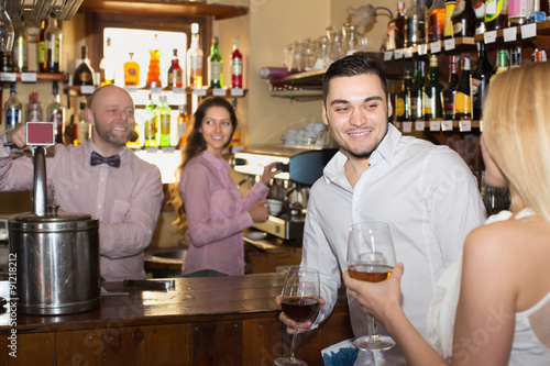 Couple drinking wine at bar