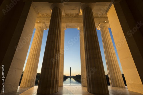 Standing inside the Lincoln Memorial looking at the Washington Monument at sunrise