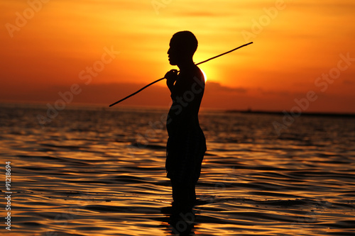 Silhouette of a man with a fishing stick on Lake Turkana at sunset