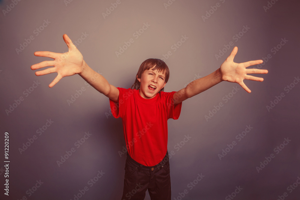 European-looking boy of ten years held out his hands, palms forw European-looking boy of ten years held out his hands, palms forw