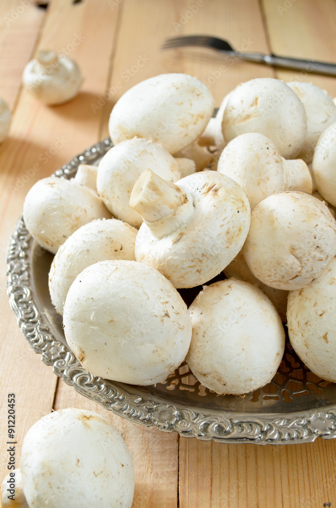 raw champignons on wooden background raw champignons on wooden background