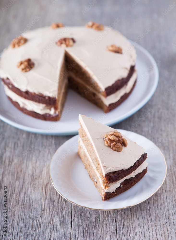 Homemade coffee and walnut cake on the dark wooden table Homemade coffee and walnut cake on the dark wooden table