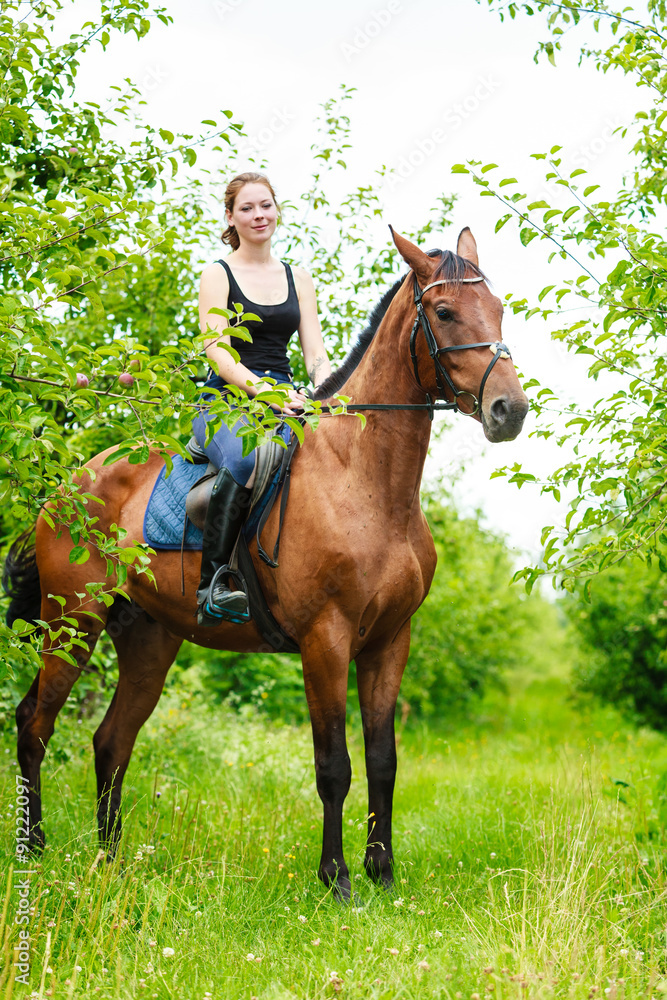 Fototapeta premium Woman jockey training riding horse. Sport activity