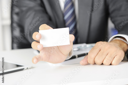 Man's hand showing business card