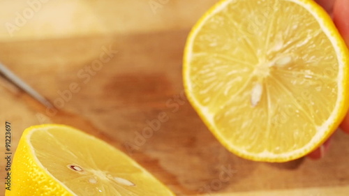 Cutting lemon on wooden background
