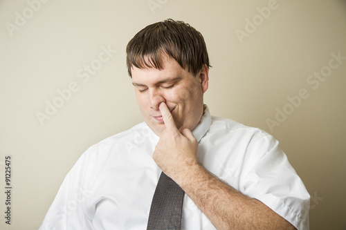 Fotografija Business man picking his nose