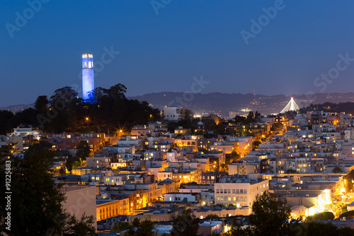 Coit tower and houses in San Francisco at night