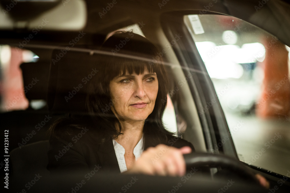 Senior business woman driving car