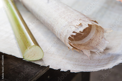 Rolled papyrus paper and the stem of the plant laid on a papyrus layer photo