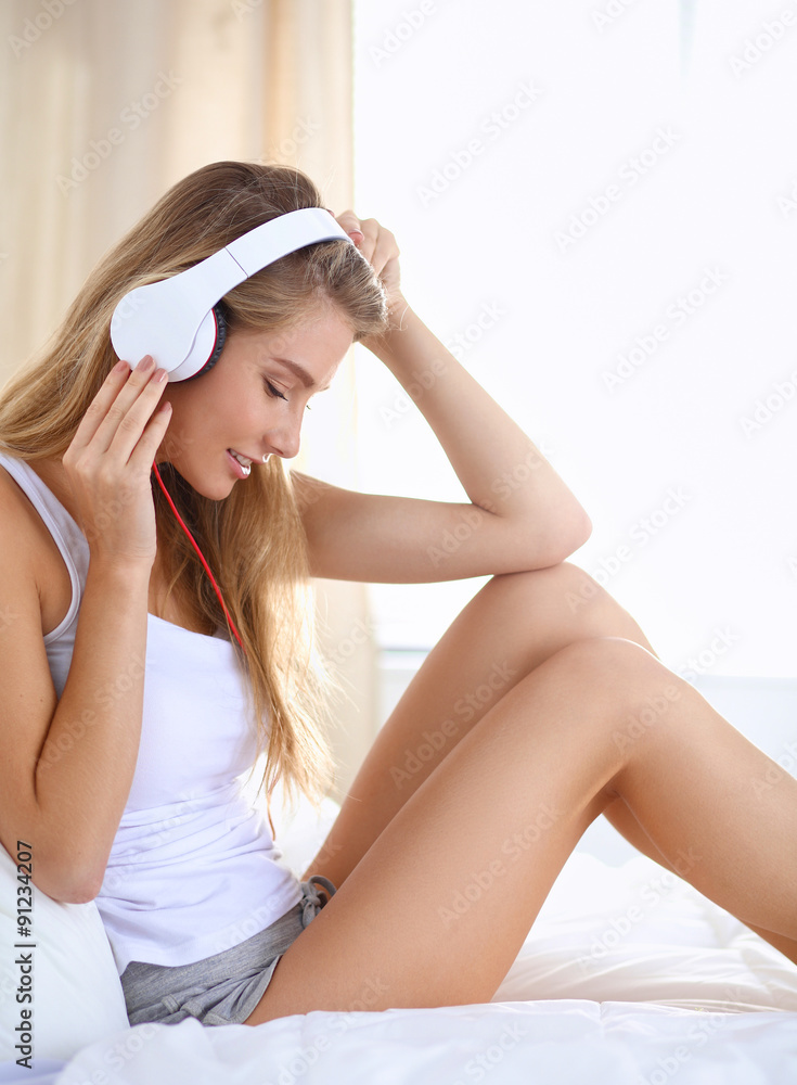 Fototapeta premium Portrait of beautiful woman in morning listening music sitting