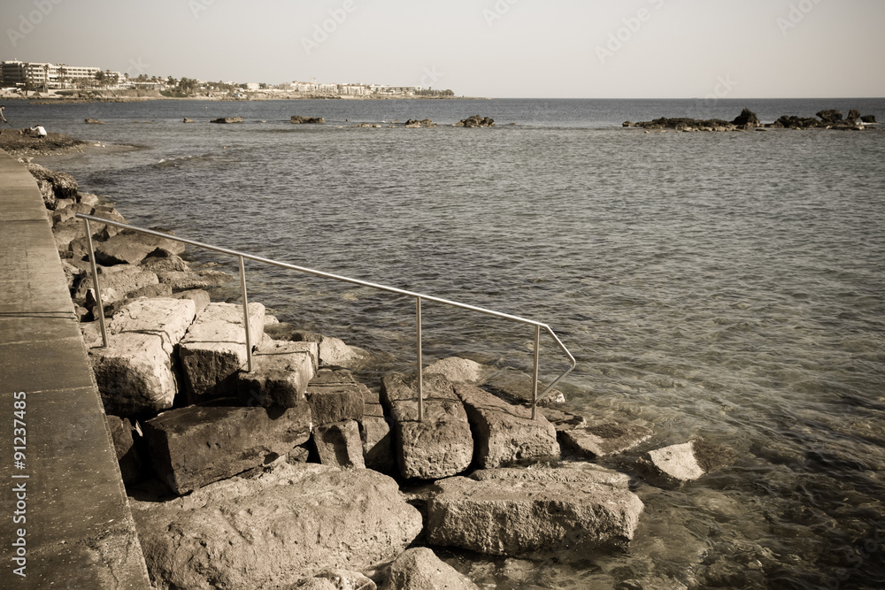 The rocky slope to the waterfront to the water of the Mediterran