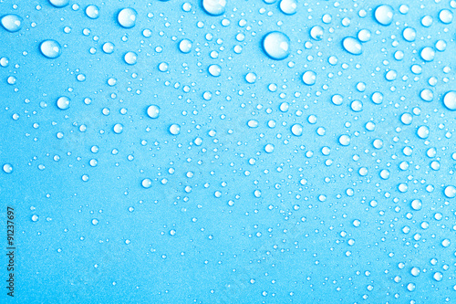 Drops of water on a color background. Blue. Shallow depth of fie