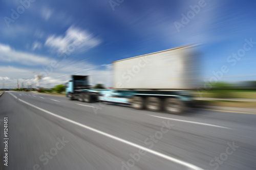 Generic big trucks speeding on the highway at sunset - Transport industry concept , big truck containers © sittinan