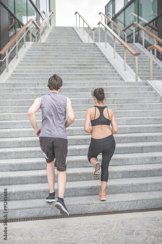 Obraz premium Rear view of couple exercising on steps