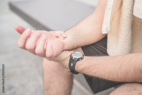 close up of sportive man hands counting heartbeat