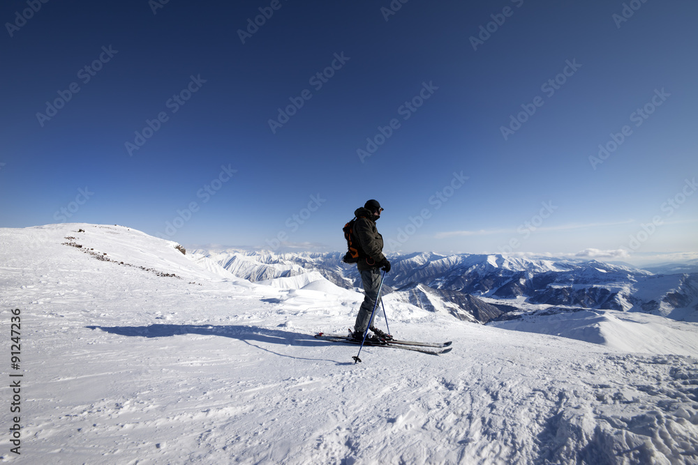 Skier on top of ski slope
