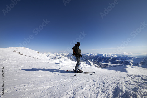 Skier on top of ski slope