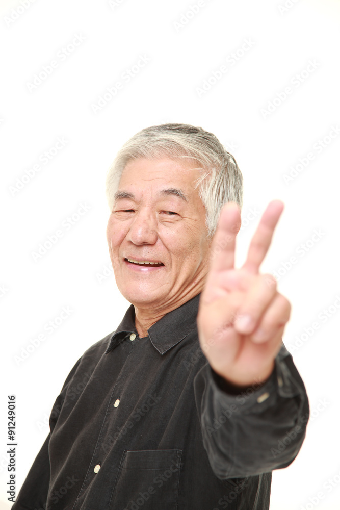 senior Japanese man showing a victory sign senior Japanese man showing a victory sign