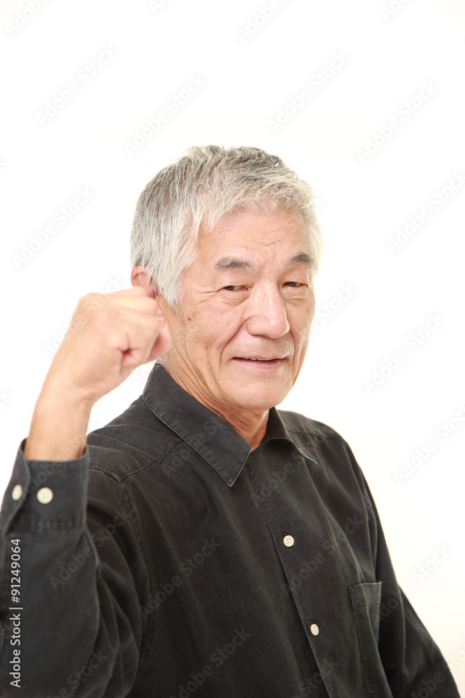 senior Japanese man in a victory pose senior Japanese man in a victory pose