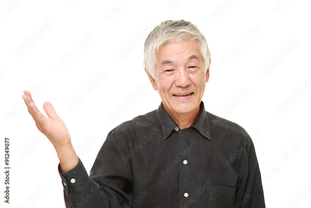 senior Japanese man presenting and showing something senior Japanese man presenting and showing something