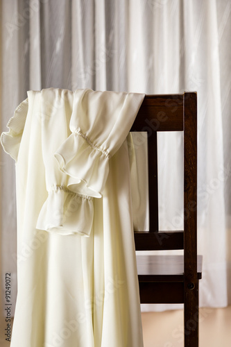 White dress draped over chair
