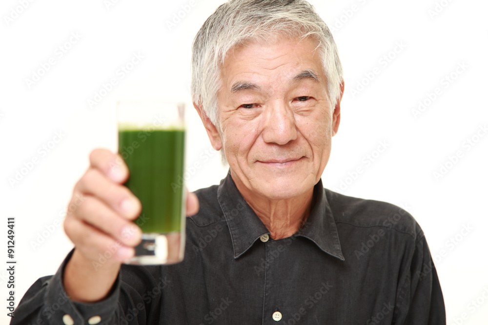 senior Japanese man with green vegetable juice senior Japanese man with green vegetable juice