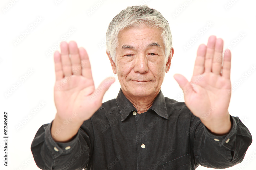 senior Japanese man making stop gesture senior Japanese man making stop gesture