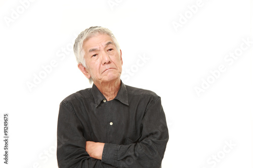 senior Japanese man worries about something