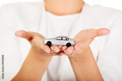Young businesswoman holding a toy car