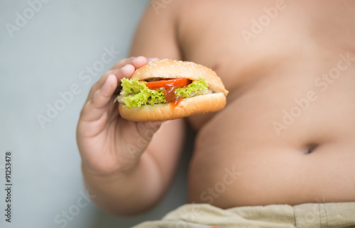 chicken cheese Hamburger on obese fat boy hand photo