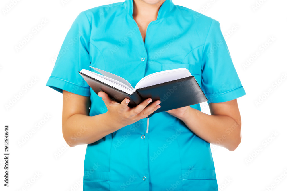 Young female doctor or nurse holding black notes Young female doctor or nurse holding black notes