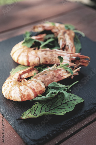 Grilled shrimps on slate plate