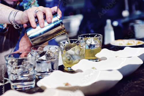 Bartender is making cocktail at bar counter