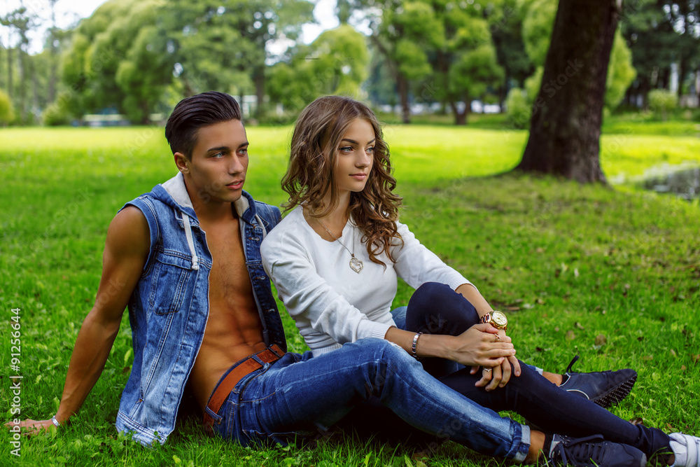 Man with woman relaxing on grass in a park. Man with woman relaxing on grass in a park.